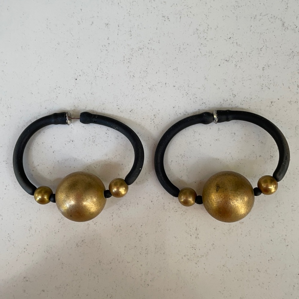 Earrings. Are of black rubber w/gold beads